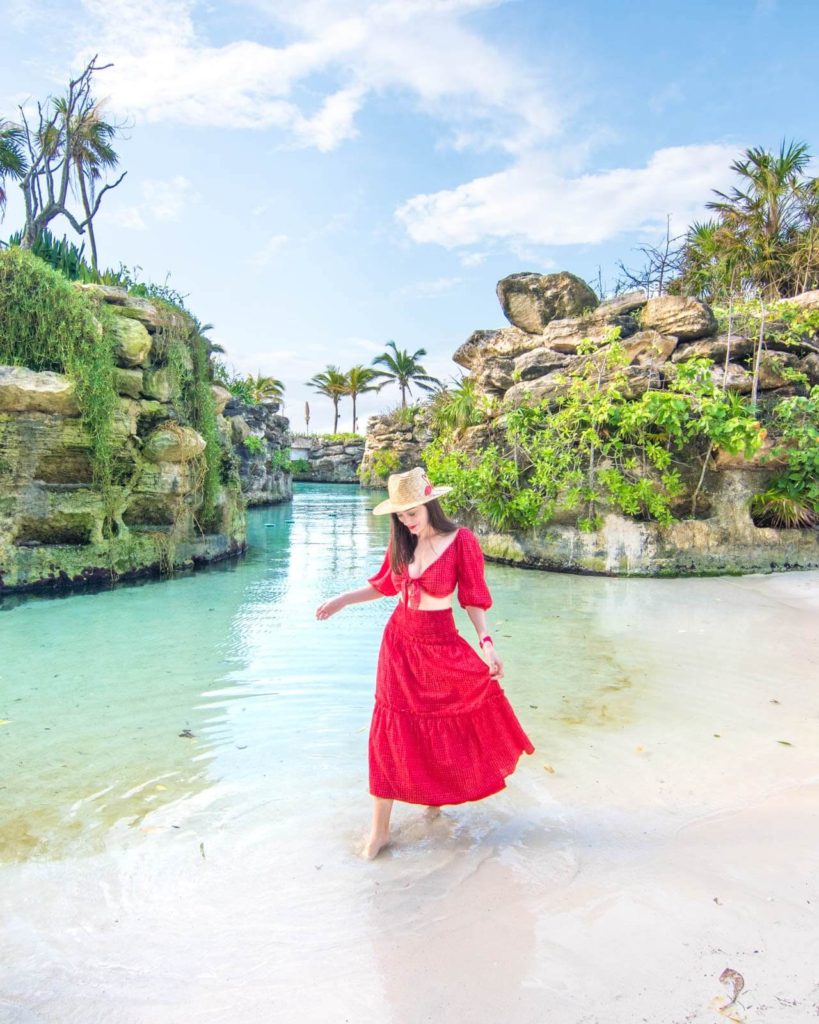Girl walking near water at the beach at Hotel Xcaret Mexico