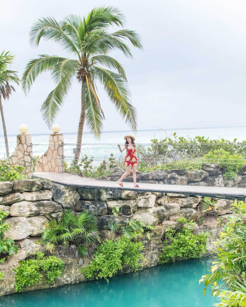 Girl walking over hanging bridge at Hotel Xcaret Mexico
