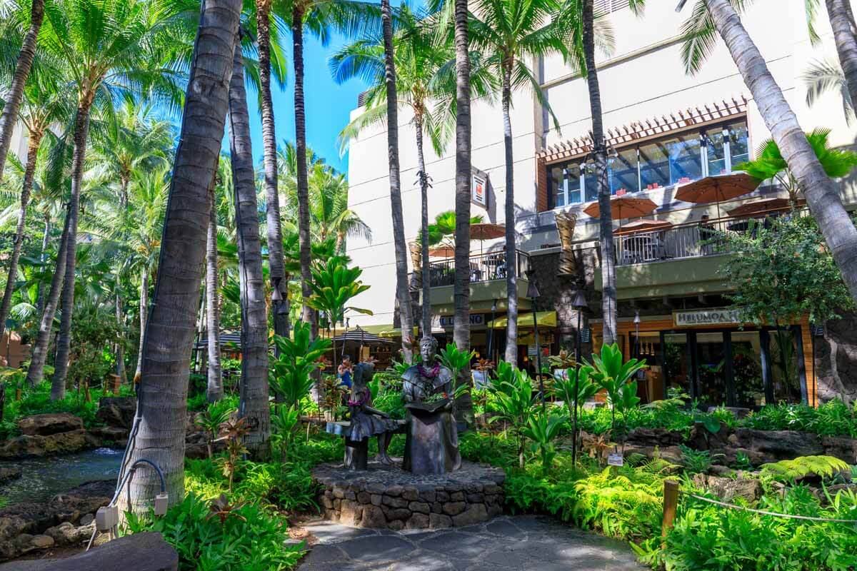 Green area surrounded by shops in the Royal Hawaiian Center in Honolulu, Hawaii.