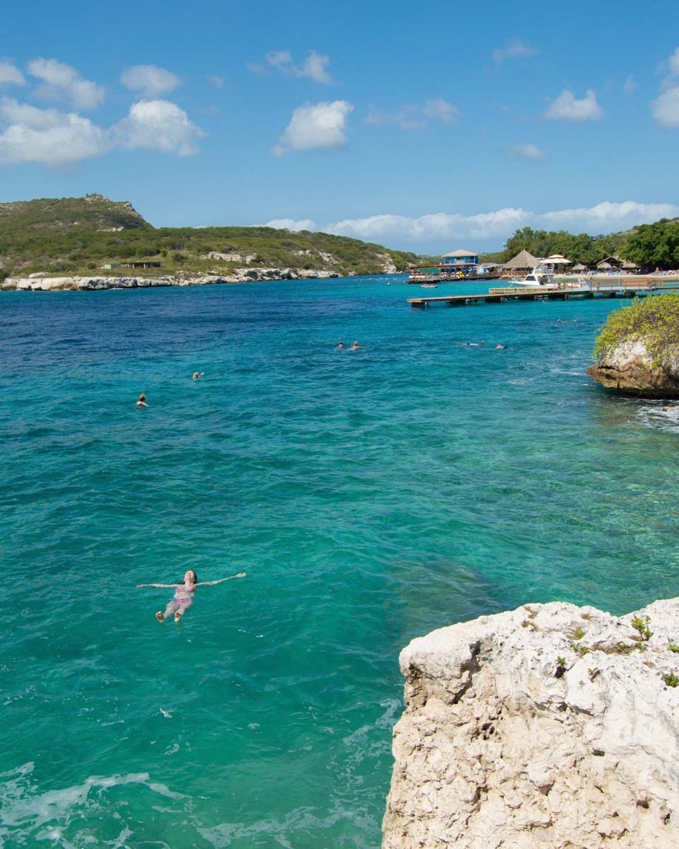 Woman floating in ocean in Willemstad, Curaçao