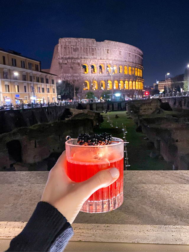 Cocktail in front of the Colosseum at night in Rome, Italy